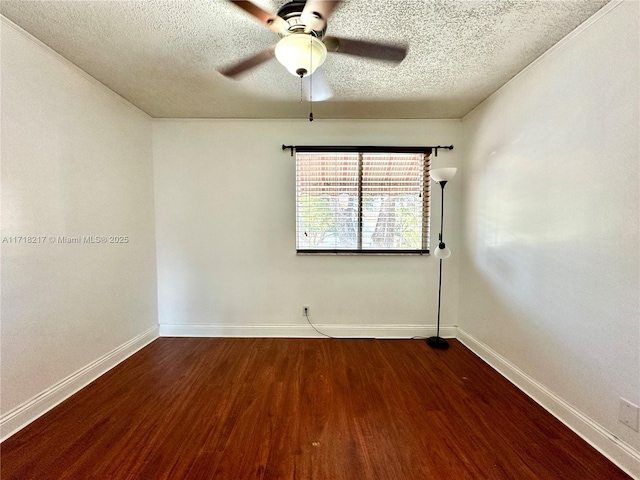 empty room featuring a textured ceiling, ceiling fan, and dark wood-type flooring