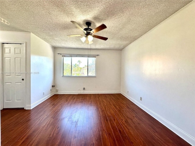 spare room with dark hardwood / wood-style floors, ceiling fan, and a textured ceiling