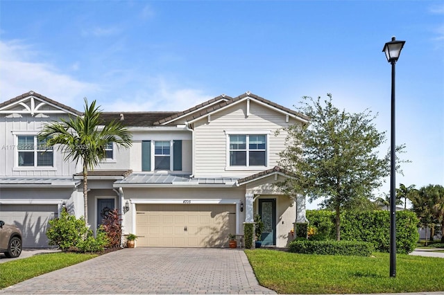 view of front of home featuring a garage and a front yard