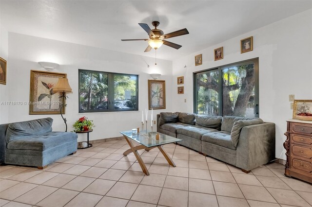 dining space featuring light tile patterned floors and ceiling fan with notable chandelier