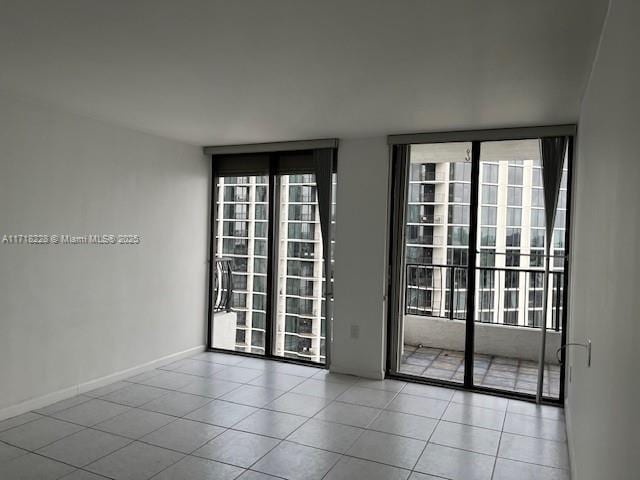 empty room featuring floor to ceiling windows and a wealth of natural light