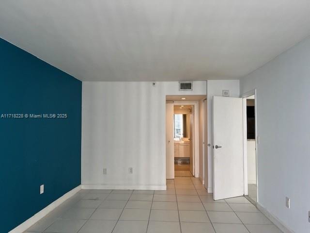 unfurnished room featuring light tile patterned flooring