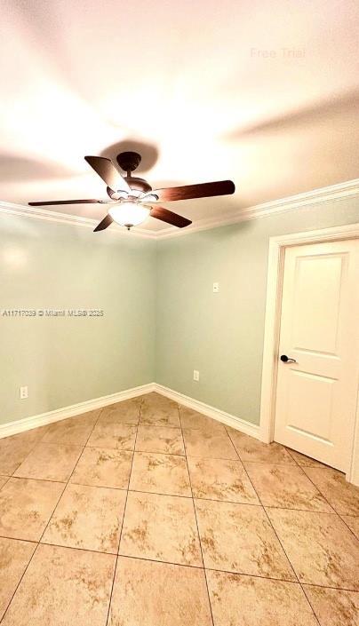 unfurnished room featuring tile patterned flooring and crown molding