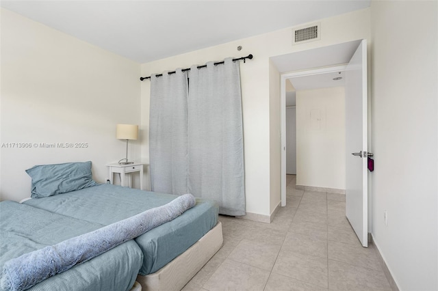 bedroom with light tile patterned floors