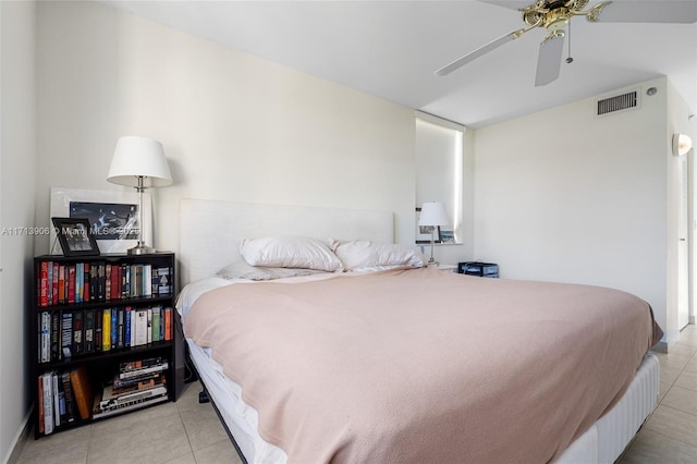 bedroom with ceiling fan and light tile patterned flooring