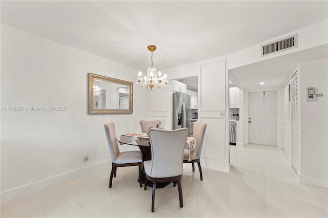 dining space with a notable chandelier