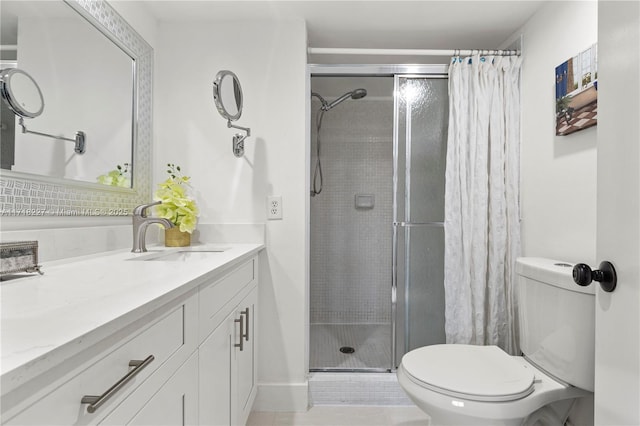 bathroom with vanity, a shower with shower curtain, and toilet