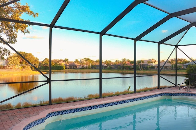 view of pool featuring a water view and a lanai