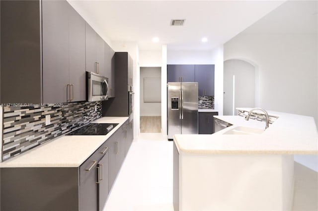 kitchen featuring backsplash, sink, and stainless steel appliances