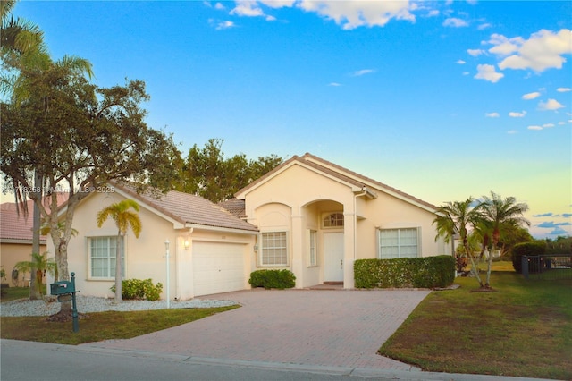 view of front of property featuring a lawn and a garage