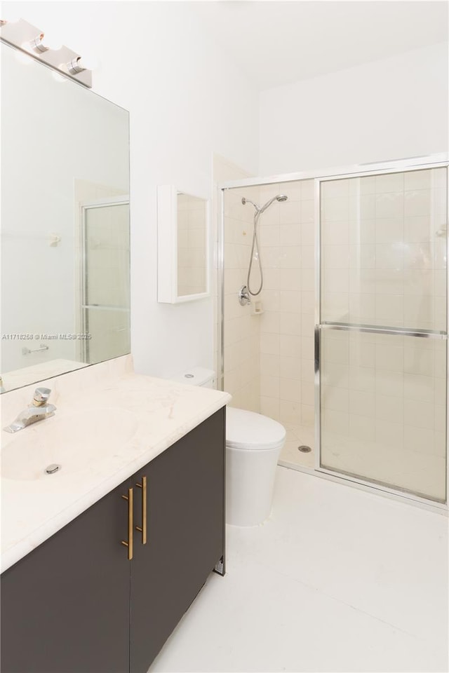 bathroom with vanity, toilet, and walk in shower