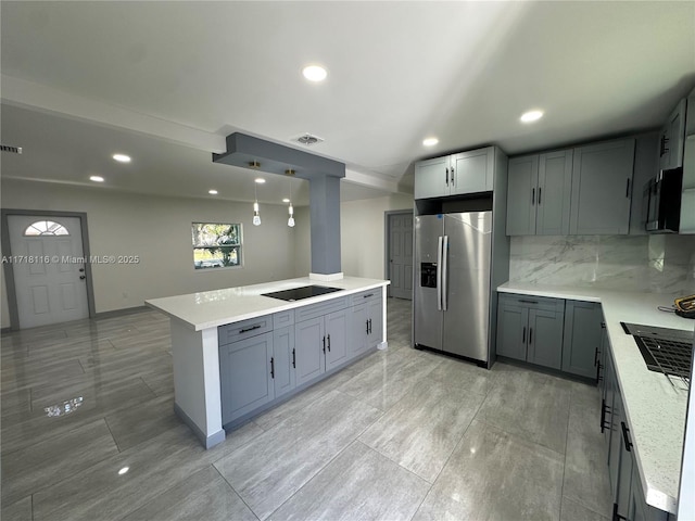 kitchen with gray cabinetry, a center island, black electric cooktop, decorative light fixtures, and stainless steel fridge with ice dispenser