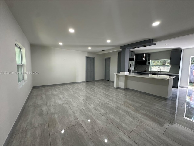 unfurnished living room with sink