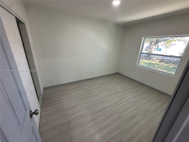 empty room with light hardwood / wood-style floors