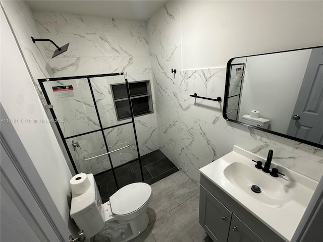 bathroom featuring a tile shower, vanity, toilet, and tile walls