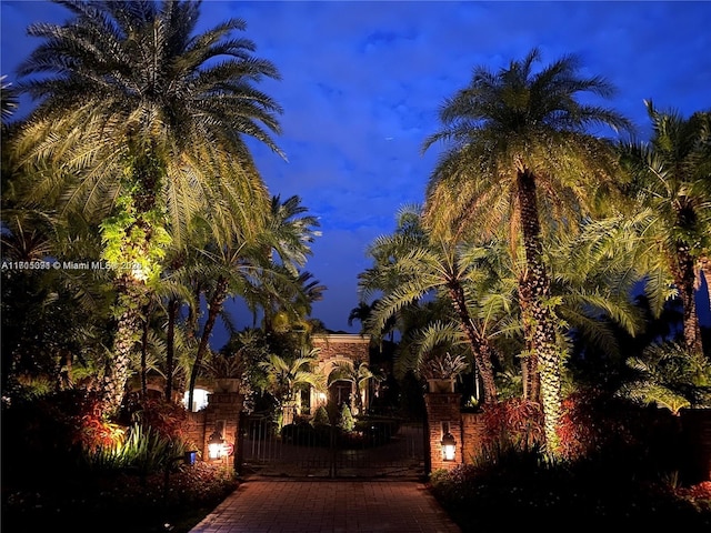 property exterior at night with a gate