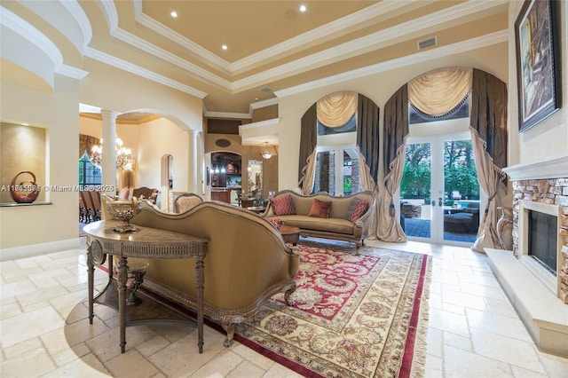 living area with visible vents, stone tile flooring, french doors, and decorative columns