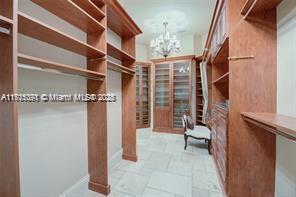 walk in closet featuring an inviting chandelier