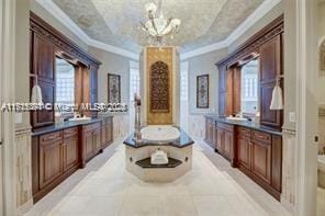 bathroom with a wealth of natural light, crown molding, and two vanities