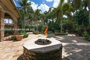 view of patio with an outdoor fire pit