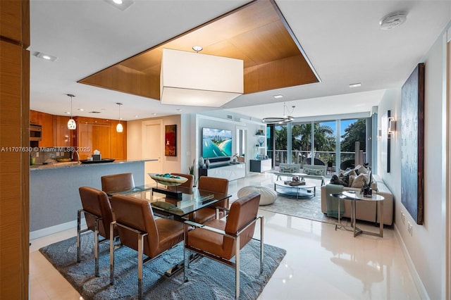 dining room with a tray ceiling and ceiling fan