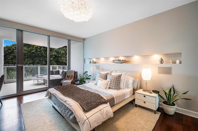 bedroom featuring access to exterior and dark wood-type flooring