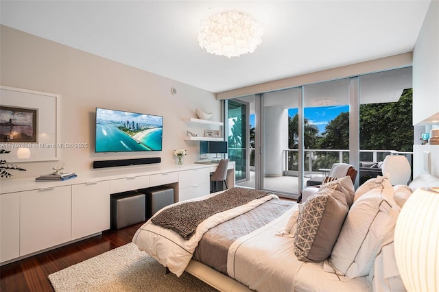 bedroom featuring dark hardwood / wood-style floors, access to outside, and multiple windows