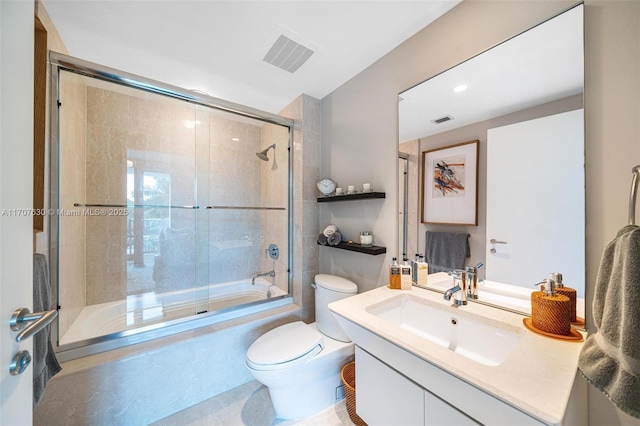 full bathroom with vanity, toilet, and combined bath / shower with glass door