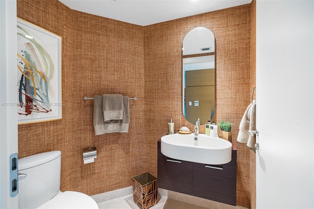 bathroom featuring tile patterned floors, vanity, and toilet