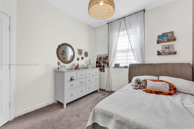 carpeted bedroom with lofted ceiling