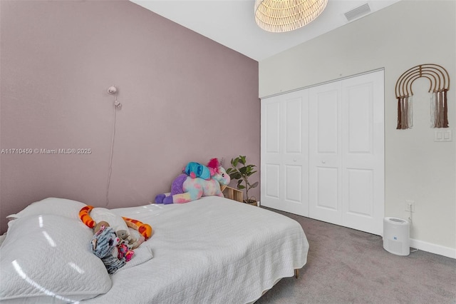 carpeted bedroom featuring a closet and lofted ceiling