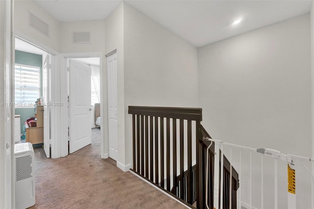 hallway with carpet floors