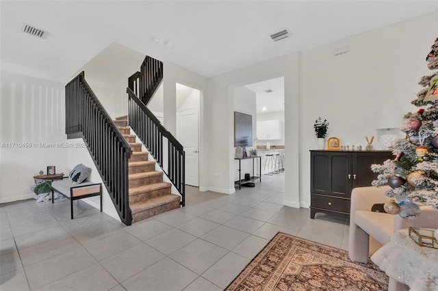 staircase featuring tile patterned flooring