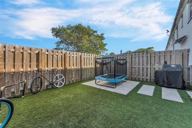 view of yard with a patio and a trampoline