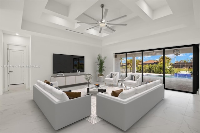 living room with coffered ceiling, beam ceiling, ceiling fan, and a towering ceiling