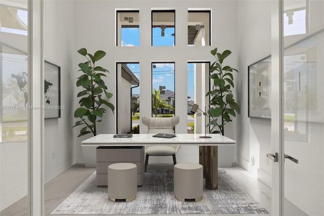 interior space with french doors and a towering ceiling