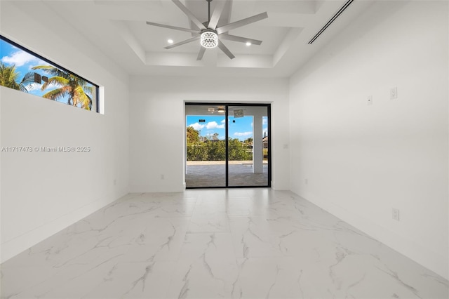 empty room featuring ceiling fan and a towering ceiling