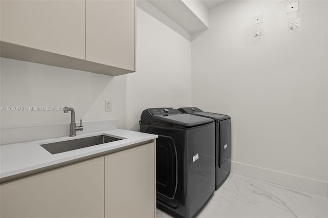 washroom with separate washer and dryer, sink, and cabinets