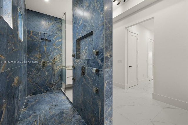 bathroom with vanity and tiled shower