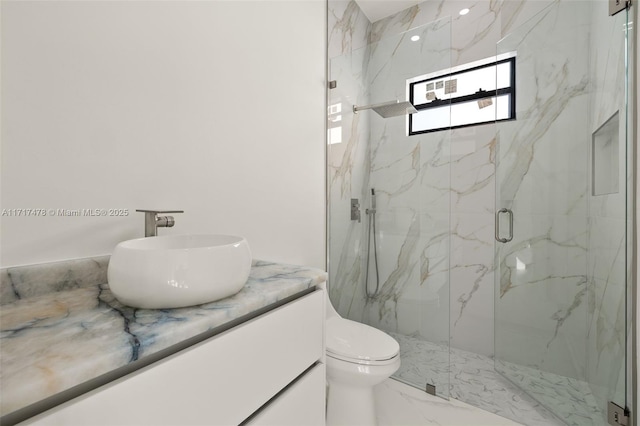 bathroom with an enclosed shower, vanity, and toilet