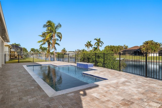 view of pool with a patio area and a water view