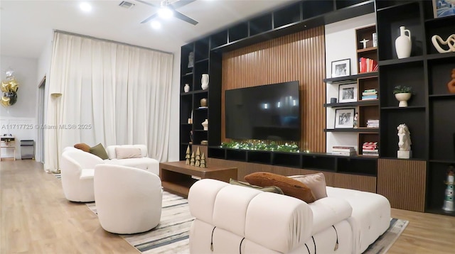 living room featuring ceiling fan and wood-type flooring