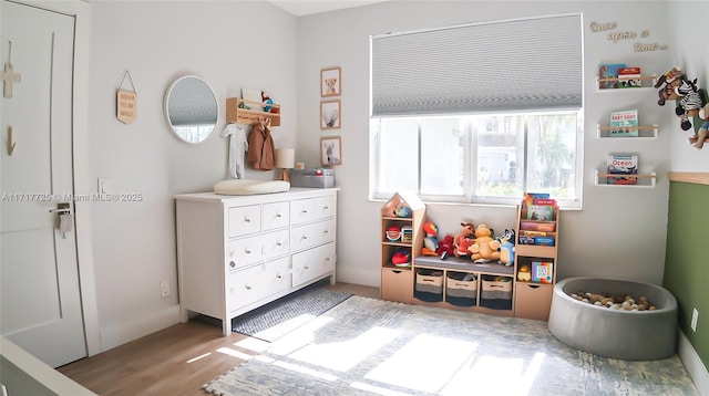 rec room with light hardwood / wood-style flooring