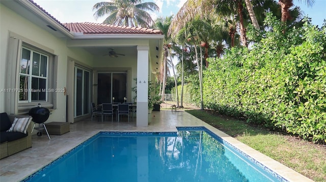 view of swimming pool with ceiling fan and a patio