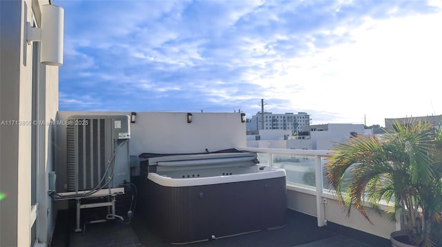 view of patio featuring central AC and a balcony