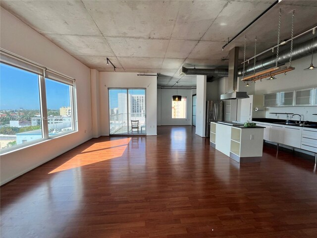 kitchen with white dishwasher, dark hardwood / wood-style floors, cooktop, and white cabinetry