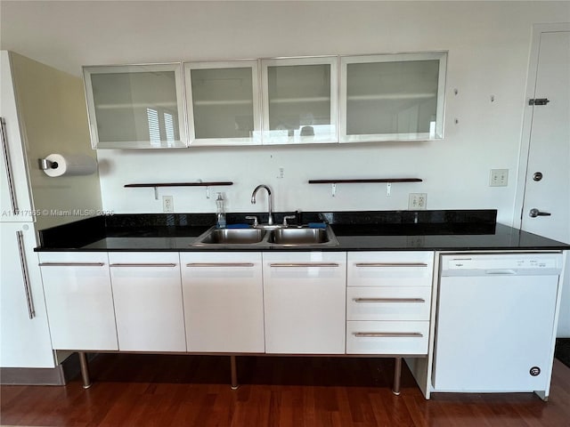 kitchen featuring dark wood-type flooring, dishwasher, sink, and white cabinets