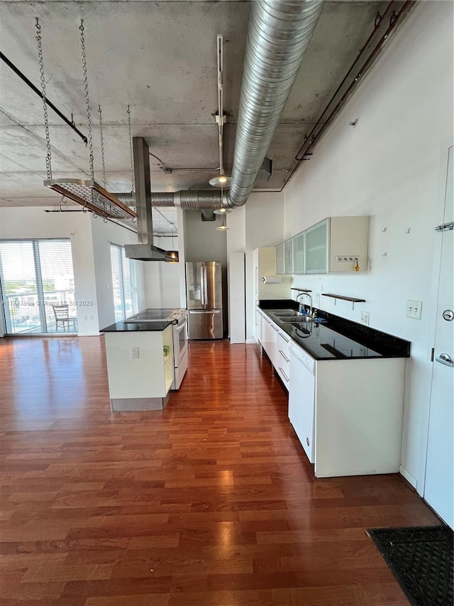 kitchen with dark wood-type flooring, sink, island exhaust hood, white cabinetry, and white appliances