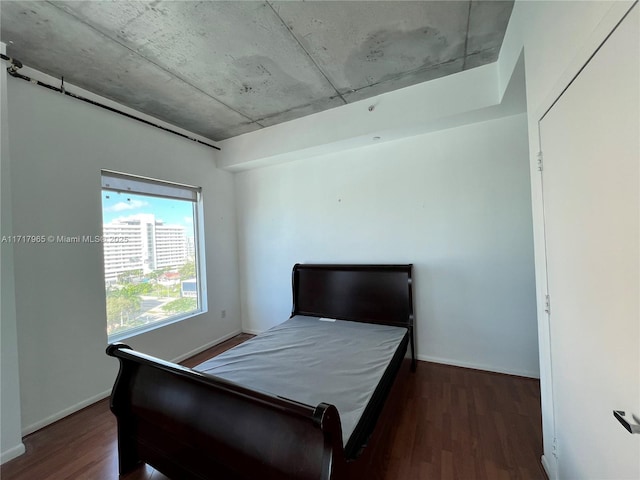 bedroom with dark hardwood / wood-style floors