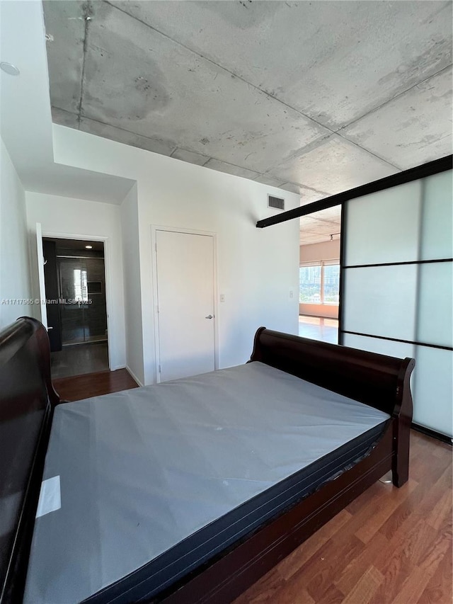 unfurnished bedroom with hardwood / wood-style flooring